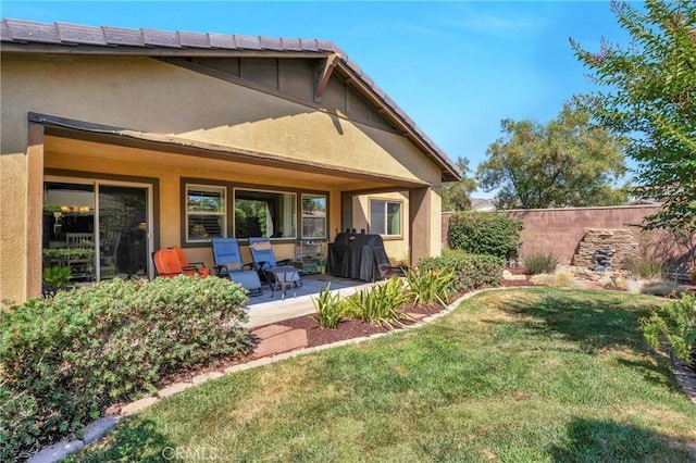 29183 Jacaranda, Lake Elsinore, CA 92530 - rear view of property featuring stucco siding, a yard, and a porch