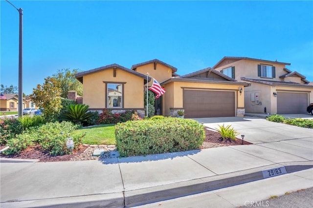 29183 Jacaranda, Lake Elsinore, CA 92530 - view of front facade with stucco siding, an attached garage, driveway, and stone siding