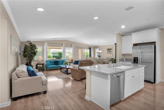 29183 Jacaranda, Lake Elsinore, CA 92530 - kitchen with stainless steel appliances, ornamental molding, open floor plan, lofted ceiling, and a kitchen island with sink