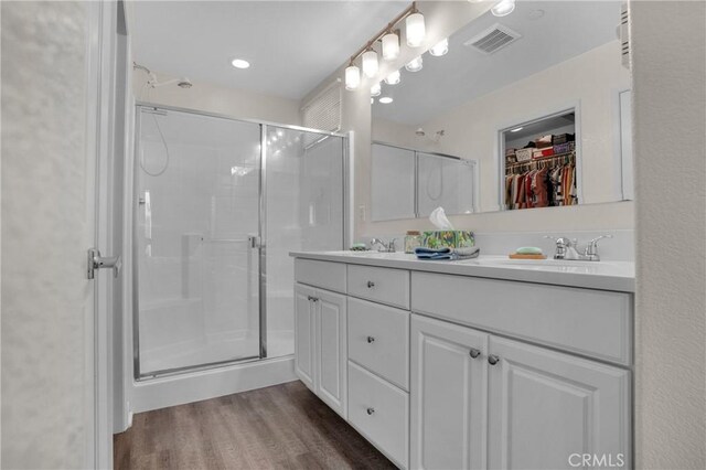 29183 Jacaranda, Lake Elsinore, CA 92530 - bathroom featuring a shower stall, double vanity, wood finished floors, and a spacious closet
