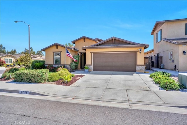 29183 Jacaranda, Lake Elsinore, CA 92530 - view of front of home featuring an attached garage, concrete driveway, stucco siding, and stone siding