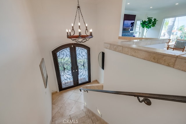 1906 S Patton Ave, San Pedro, CA 90732 - entrance foyer featuring french doors, a chandelier, arched walkways, light tile patterned flooring, and ornamental molding