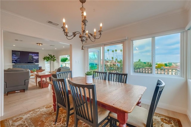 1906 S Patton Ave, San Pedro, CA 90732 - dining area with light wood-style floors, a chandelier, healthy amount of natural light, and ornamental molding