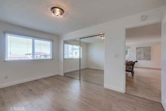 1906 S Patton Ave, San Pedro, CA 90732 - unfurnished bedroom featuring crown molding, light wood-type flooring, and a closet
