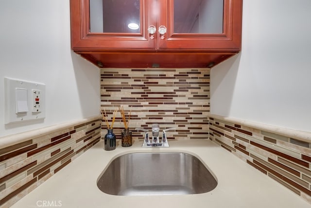 1906 S Patton Ave, San Pedro, CA 90732 - detailed view of backsplash, reddish brown cabinets, light countertops, and glass insert cabinets