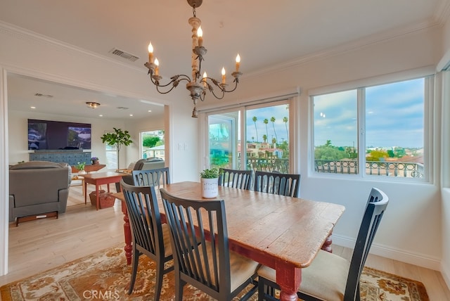 1906 S Patton Ave, San Pedro, CA 90732 - dining area with light wood-style floors, a chandelier, and ornamental molding
