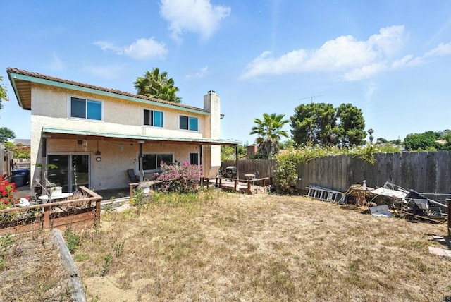 250 65th St, San Diego, CA 92114 - back of property with stucco siding, a fenced backyard, a chimney, and a patio
