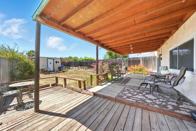250 65th St, San Diego, CA 92114 - wooden deck with outdoor dining space, a shed, and a fenced backyard