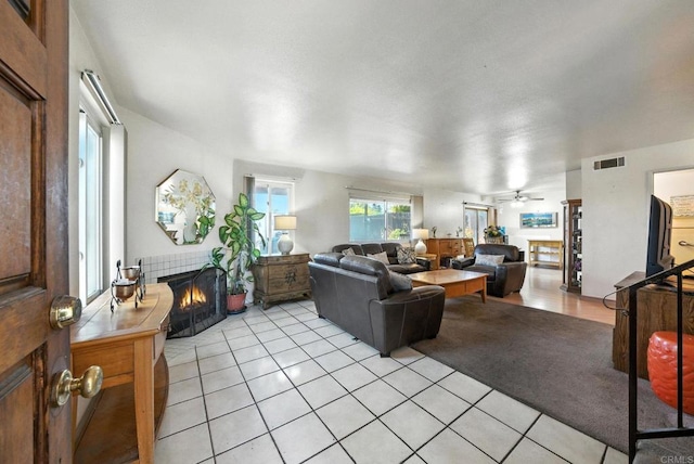 250 65th St, San Diego, CA 92114 - living area featuring a tiled fireplace, light tile patterned flooring, and ceiling fan