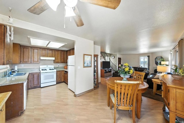 250 65th St, San Diego, CA 92114 - kitchen featuring white appliances, light countertops, open floor plan, and brown cabinetry