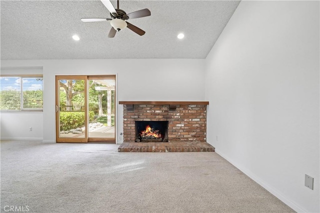 2065 N Shorewood Ave, Upland, CA 91784 - unfurnished living room featuring a textured ceiling, carpet floors, a fireplace, a ceiling fan, and recessed lighting