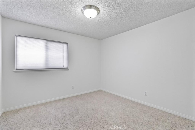 2065 N Shorewood Ave, Upland, CA 91784 - carpeted spare room with a textured ceiling and baseboards
