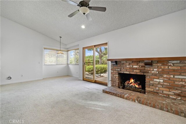2065 N Shorewood Ave, Upland, CA 91784 - unfurnished living room with a textured ceiling, carpet flooring, vaulted ceiling, a fireplace, and ceiling fan