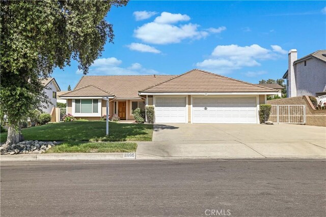 2065 N Shorewood Ave, Upland, CA 91784 - ranch-style house featuring a garage, driveway, and a tile roof