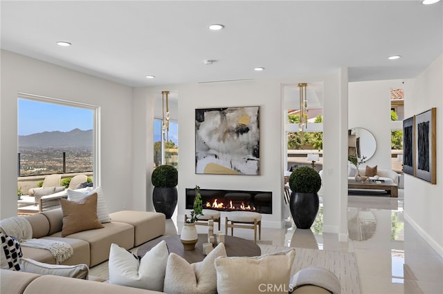 7 Sierra Vis, Laguna Niguel, CA 92677 - living room featuring recessed lighting, a mountain view, and a glass covered fireplace