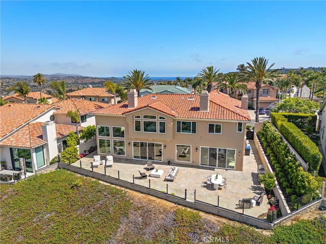 7 Sierra Vis, Laguna Niguel, CA 92677 - back of house with stucco siding, a chimney, a tile roof, and a fenced backyard