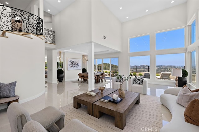 7 Sierra Vis, Laguna Niguel, CA 92677 - living room featuring a high ceiling, decorative columns, recessed lighting, and a mountain view