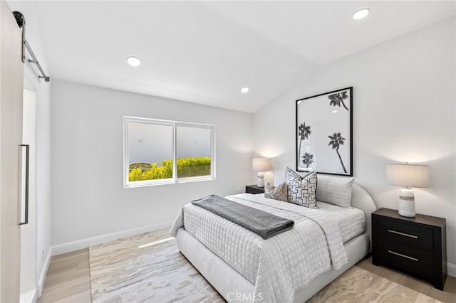 7 Sierra Vis, Laguna Niguel, CA 92677 - bedroom featuring a barn door, recessed lighting, lofted ceiling, and light wood-style floors