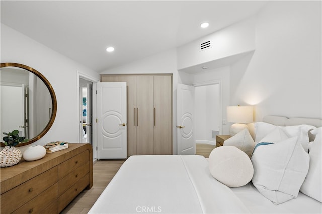 7 Sierra Vis, Laguna Niguel, CA 92677 - bedroom featuring vaulted ceiling, light wood-type flooring, recessed lighting, and a closet