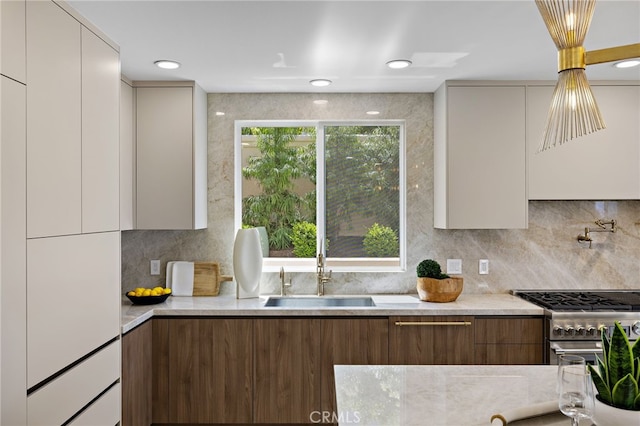 7 Sierra Vis, Laguna Niguel, CA 92677 - kitchen with modern cabinets, high end stove, and tasteful backsplash