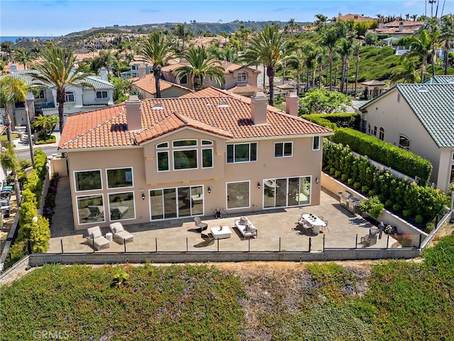 7 Sierra Vis, Laguna Niguel, CA 92677 - back of property featuring a chimney, a tile roof, stucco siding, and a patio