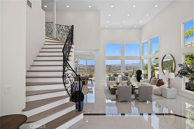 7 Sierra Vis, Laguna Niguel, CA 92677 - tiled living area featuring a high ceiling, recessed lighting, stairs, and a mountain view