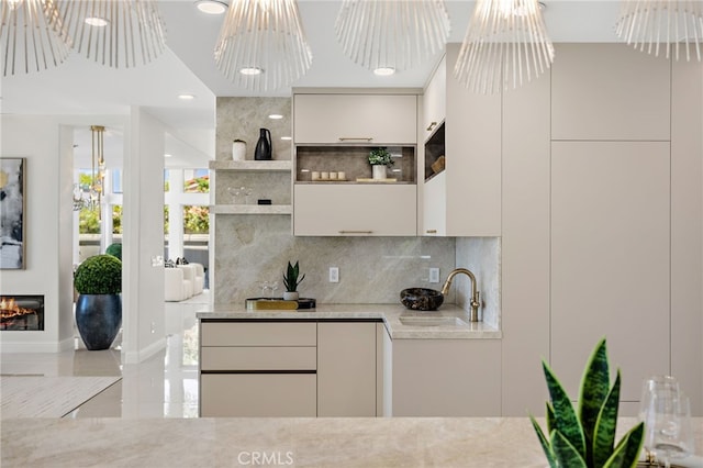 7 Sierra Vis, Laguna Niguel, CA 92677 - bar featuring decorative backsplash, a chandelier, a glass covered fireplace, decorative light fixtures, and recessed lighting