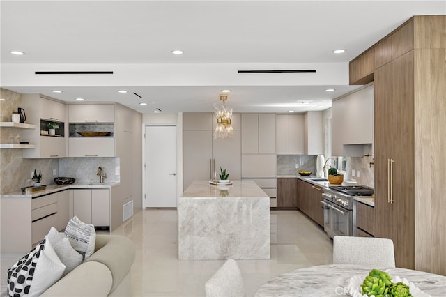7 Sierra Vis, Laguna Niguel, CA 92677 - kitchen with double oven range, modern cabinets, recessed lighting, decorative backsplash, and light countertops