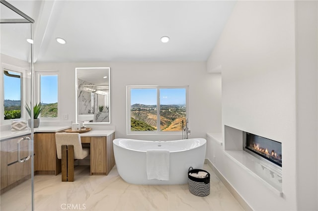7 Sierra Vis, Laguna Niguel, CA 92677 - full bath with vanity, healthy amount of natural light, a freestanding tub, a glass covered fireplace, and recessed lighting