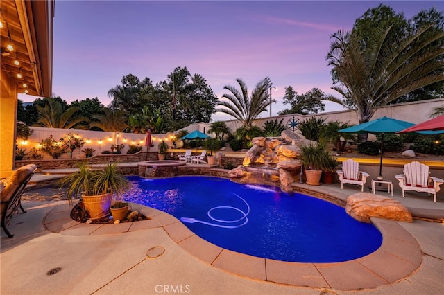 5601 Crestline Pl, Rancho Cucamonga, CA 91739 - pool at dusk featuring a patio area, a fenced backyard, and a pool with connected hot tub