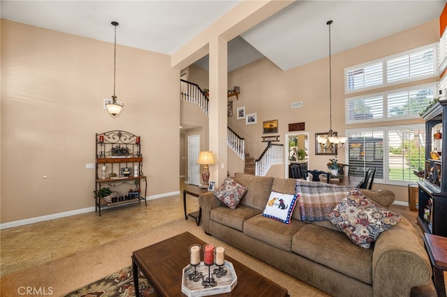 5601 Crestline Pl, Rancho Cucamonga, CA 91739 - living room featuring stairs, a chandelier, a towering ceiling, and tile patterned floors