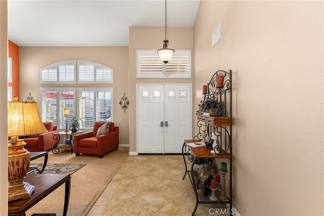5601 Crestline Pl, Rancho Cucamonga, CA 91739 - foyer featuring a towering ceiling, light tile patterned floors, and light colored carpet