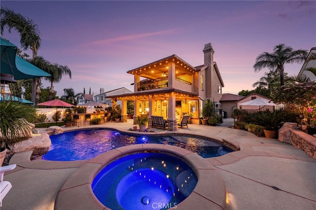 5601 Crestline Pl, Rancho Cucamonga, CA 91739 - pool at dusk featuring an in-ground hot tub, a patio, and an outdoor pool