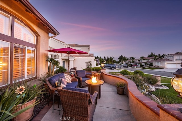 5601 Crestline Pl, Rancho Cucamonga, CA 91739 - patio terrace at dusk featuring a fire pit and a patio area