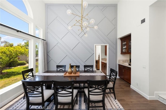 5914 Johnston Pl, Rancho Cucamonga, CA 91739 - dining room with a towering ceiling, a chandelier, and dark wood-style floors