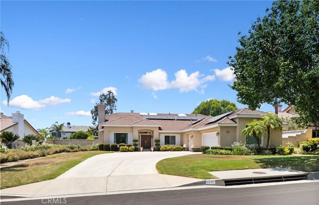 5914 Johnston Pl, Rancho Cucamonga, CA 91739 - mediterranean / spanish-style house featuring roof mounted solar panels, stucco siding, an attached garage, concrete driveway, and a front lawn