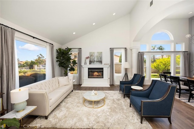 5914 Johnston Pl, Rancho Cucamonga, CA 91739 - living room with high vaulted ceiling, wood finished floors, a glass covered fireplace, healthy amount of natural light, and recessed lighting