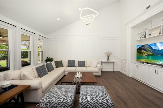 5914 Johnston Pl, Rancho Cucamonga, CA 91739 - living room with a decorative wall, dark wood-type flooring, a chandelier, wainscoting, and high vaulted ceiling