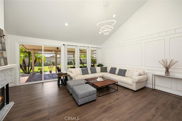 5914 Johnston Pl, Rancho Cucamonga, CA 91739 - living room with a decorative wall, a lit fireplace, a chandelier, dark wood-style floors, and recessed lighting
