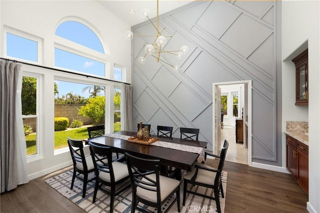 5914 Johnston Pl, Rancho Cucamonga, CA 91739 - dining area featuring plenty of natural light, high vaulted ceiling, a decorative wall, a chandelier, and dark wood-style flooring