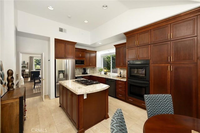 5914 Johnston Pl, Rancho Cucamonga, CA 91739 - kitchen with black appliances, a center island, tasteful backsplash, light stone counters, and lofted ceiling