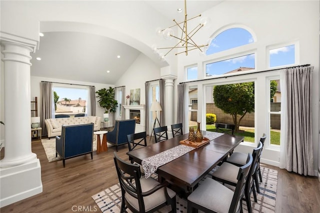 5914 Johnston Pl, Rancho Cucamonga, CA 91739 - dining space featuring decorative columns, high vaulted ceiling, recessed lighting, wood finished floors, and a chandelier