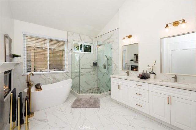 5914 Johnston Pl, Rancho Cucamonga, CA 91739 - bathroom featuring a glass covered fireplace, vaulted ceiling, a marble finish shower, a freestanding bath, and double vanity
