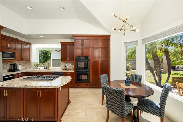 5914 Johnston Pl, Rancho Cucamonga, CA 91739 - kitchen with backsplash, a chandelier, dark brown cabinets, light stone countertops, and a center island
