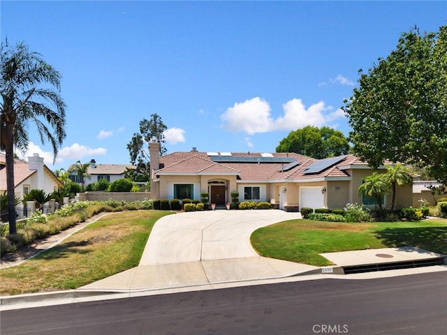 5914 Johnston Pl, Rancho Cucamonga, CA 91739 - view of front of home featuring stucco siding, a front yard, roof mounted solar panels, concrete driveway, and an attached garage