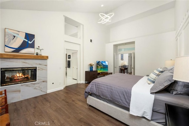 5914 Johnston Pl, Rancho Cucamonga, CA 91739 - bedroom with a chandelier, wood finished floors, a high end fireplace, and high vaulted ceiling