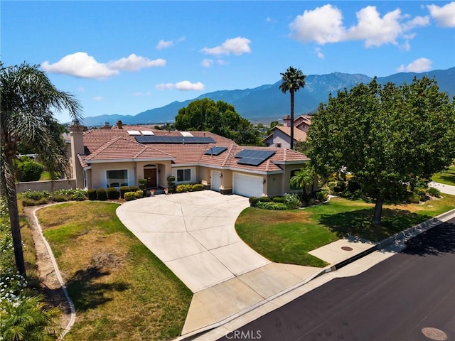 5914 Johnston Pl, Rancho Cucamonga, CA 91739 - mediterranean / spanish house featuring a mountain view, an attached garage, driveway, and a front lawn