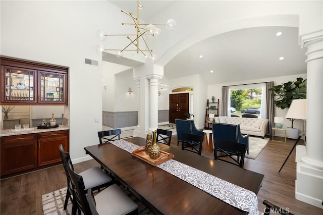 5914 Johnston Pl, Rancho Cucamonga, CA 91739 - dining space with ornate columns, arched walkways, dark wood-style floors, recessed lighting, and high vaulted ceiling