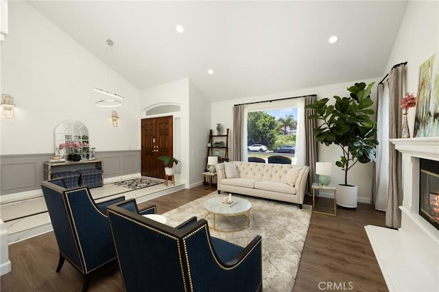5914 Johnston Pl, Rancho Cucamonga, CA 91739 - living area featuring dark wood finished floors, a glass covered fireplace, recessed lighting, wainscoting, and high vaulted ceiling