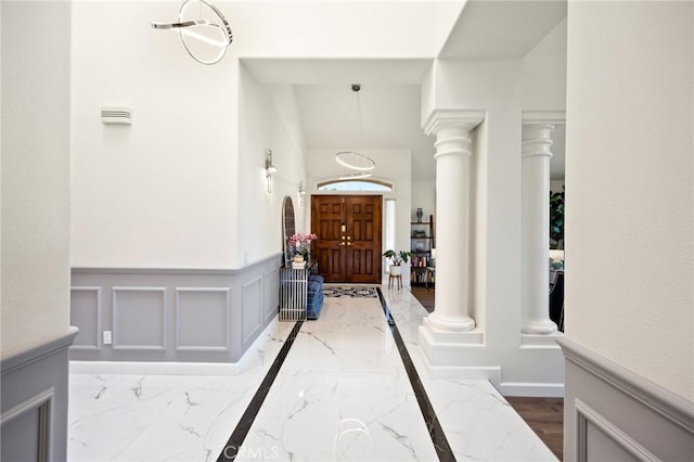 5914 Johnston Pl, Rancho Cucamonga, CA 91739 - foyer entrance featuring marble tiled flooring, decorative columns, wainscoting, and a decorative wall